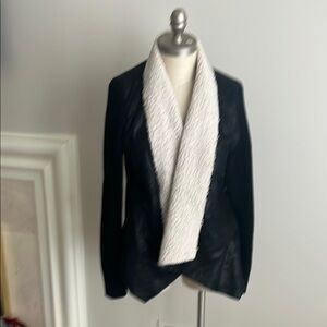Sheepskin fur collared jacket with sweater sleeves and black lightweight bodice.